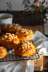 Freshly baked homemade traditional Czech Moravian buns (kolače) with cottage cheese , apple and crumbs on cooling rake.