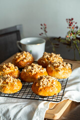 Freshly baked homemade traditional Czech Moravian buns (kolače) with cottage cheese , apple and crumbs on cooling rake.
