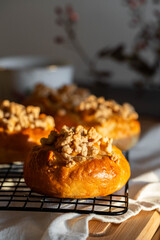Freshly baked homemade traditional Czech Moravian buns (kolače) with cottage cheese , apple and crumbs on cooling rake.