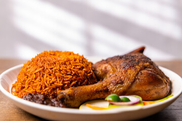 Ghanaian Jollof Rice with Grilled Chicken, Long-grain rice cooked in a rich tomato and pepper sauce, a popular traditional dish from West Africa