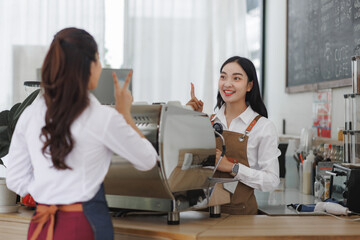 Barista helping customer with coffee order
