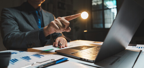 Businessman pointing finger at laptop screen