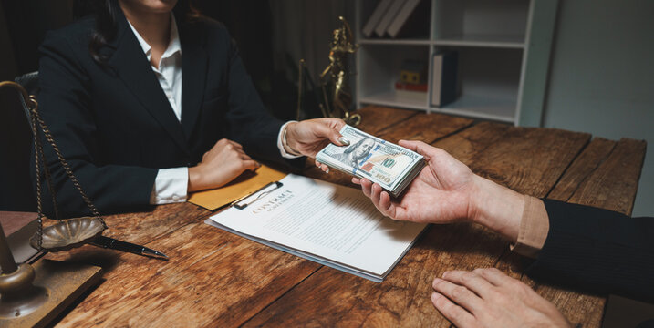 Person handing money over contract agreement