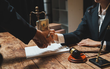 Businessmen shaking hands accepting bribe money