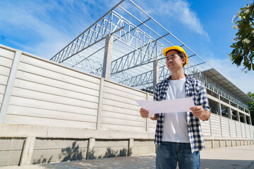 Engineer reviewing building plans at construction site
