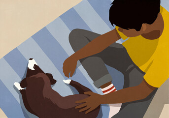 High angle view boy petting dog on rug
