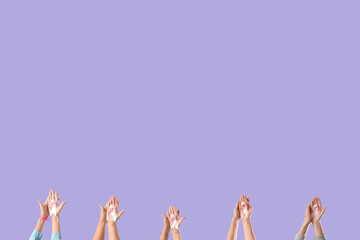 Many female hands with pink awareness ribbons on lilac background. Breast cancer concept