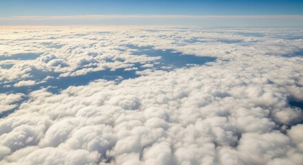 Naklejka premium Vast ocean of fluffy white clouds under a bright blue sky