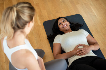 Smiling woman relaxes on mat after workout session