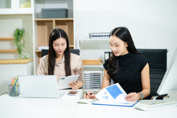 Business portrait two woman asian  smile cheerful talk and holding tablet, computer with in agreement ready new project job for work in room office company