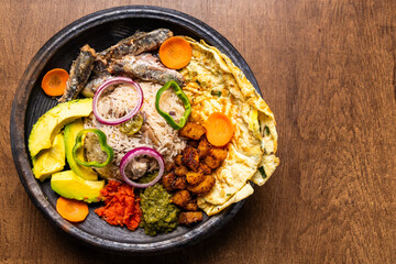 Anwamo (Oiled Rice), Africa Ghana Traditional Dish with Fried Eggs, Sardine, Avocado, and Fried Plantain