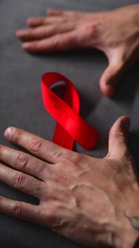 A red ribbon symbolizing solidarity with people living with HIV.
A symbol of HIV infection.
A red ribbon symbolizing support for people living with HIV.
