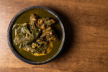 Fufu with Abunabunu and Smoked Fish, Traditional Ghanaian Dish of Pounded Cassava and Plantain Served with Green Leaf Soup, a Popular Meal from West Africa.