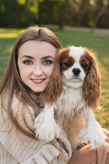 Girl and spaniel dog close-up portrait in nature