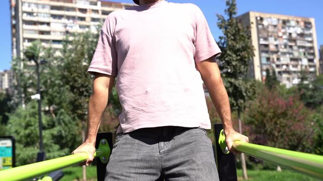 Man Training on Outdoor Bars. Urban Fitness and Street Workout