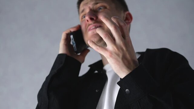 A man is yelling at his interlocutor on the phone and actively pestering him with something.
Telephone threats and conflict between people.
The man is yelling and getting very angry.