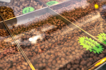 Hazelnuts coated in chocolate candy for sale at market