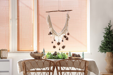 Dining table with Christmas decorations in room