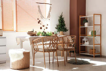 Dining table with Christmas decorations in room