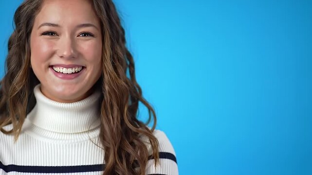 Smiling Young Woman in Turtleneck Sweater Against Vibrant Blue Background - Portrait of a Happy and Confident Female with Warm Expression and Stylish Winter Fas