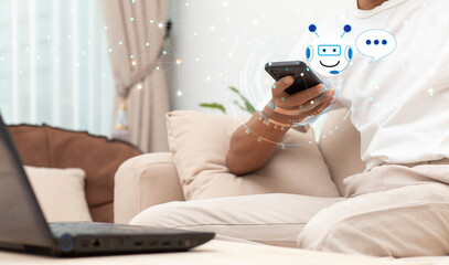 Digital chatbot, man hand chatting with chatbot customer service on mobile phone  internet mobile app. Automatic conversation assistance by AI chatbot technology during sitting at home