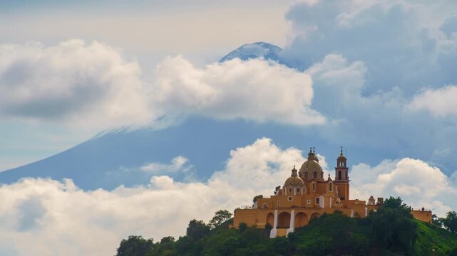 Time-lapse of Our Lady of Remedies Church atop the Great Pyramid in Cholula, Puebla, with the active Popocat&eacute;petl volcano erupting and releasing fumaroles in the background.