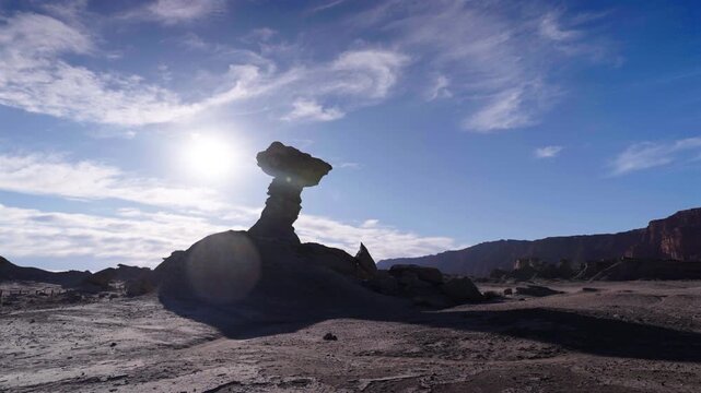 Wide shot captures the silhouette of El Hongo rock formation at Ischigualasto Valley of the Moon, Argentina, a UNESCO World Heritage Site