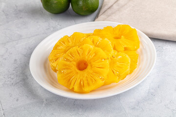 Sweet canned pineapple slices in syrope