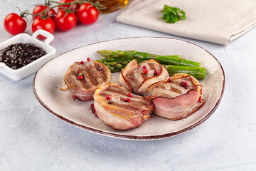 Tasty grilled pork medallion with bacon