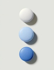 Three pastel-toned pills in a vertical stack