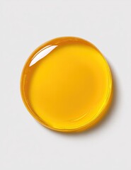 A glistening, round, amber-hued liquid droplet