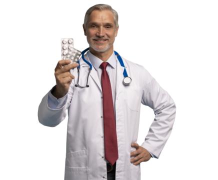 Cheerful mature male doctor holding pills in white lab coat with stethoscope, on transparent background