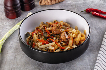 Asian cuisine udon with chicken and vegetables
