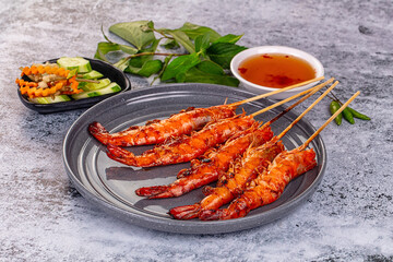 Grilled prawn skewer served sauce
