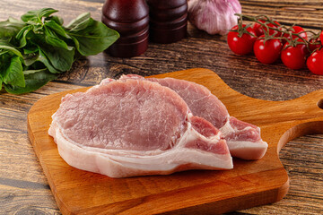 Raw pork steak over board