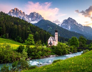 Scenic photo of a quaint church beside a river, backed by majestic mountains, bathed in the warm glow of dusk