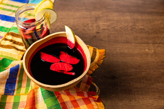 Sobolo, Hibiscus Drink, Vibrant red drink made from dried hibiscus petals, pineapple peels, ginger, cloves, and sweetened to taste