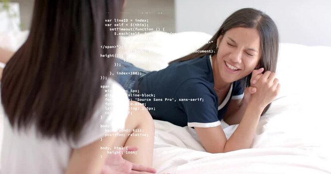 Friends chatting on white bed sparking technology code overlay scrolling across bedroom scene