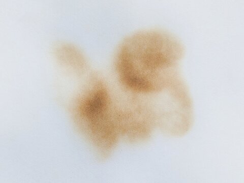 Black burn stain on round paper isolated on white paper background. Paper burned with black marks. Burnt white paper background texture.