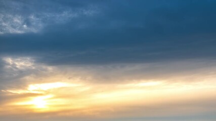 Time-lapse footage of sunset clouds bathed in golden light, creating a dreamy, ethereal atmosphere - Powered by Adobe