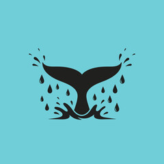 Whale Tail Emerging from Water with Splashes and Droplets.