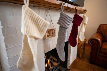Cozy christmas stockings hanging by a warm fireplace