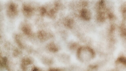 Close up of round burn stain isolated on white paper background. Burnt paper with black stain. Paper burned with black marks.