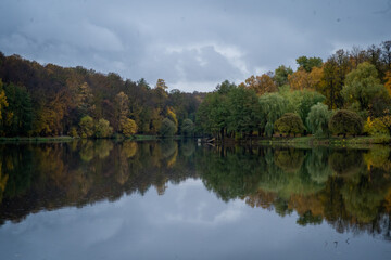 Autumn Forest Reflections on a Calm Lake Surface