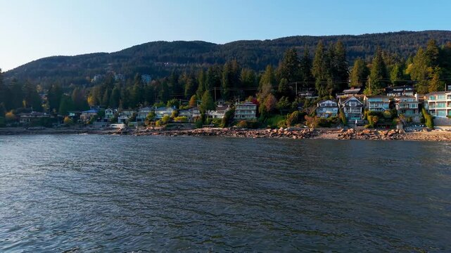 A scenic shot of a luxury suburban neighborhood along the coastline in Proctor Avenue, West Vancouver with the Brunswick Mountains on the background.