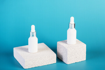 Cosmetic product in tube, bottle, lotion or serum with stylish props on red background. 