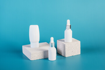 Cosmetic product in tube, bottle, lotion or serum with stylish props on red background. 
