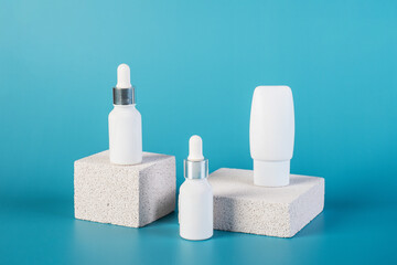 Cosmetic product in tube, bottle, lotion or serum with stylish props on red background. 