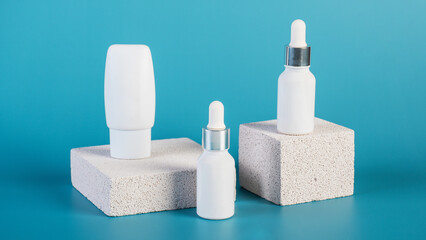 Cosmetic product in tube, bottle, lotion or serum with stylish props on red background. 