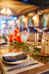 Elegant dining setup with floral decorations in a cozy restaurant at night